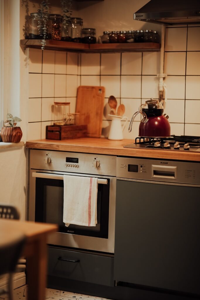 Cozy modern kitchen with built-in stainless steel wall oven, cooktop, and dishwasher for appliance repair live oak.